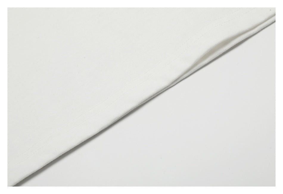 Close-up of white fabric with a diagonal stitched hem.