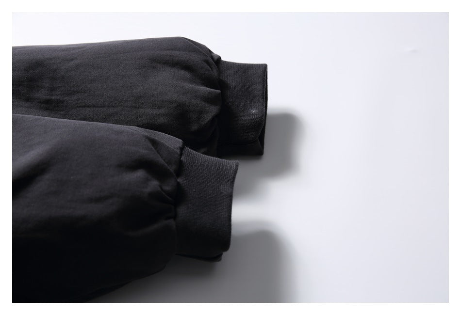 Close-up of the black jacket's sleeves and ribbed cuffs.