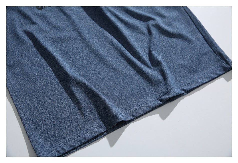 Close-up of the blue T-shirt's lower hem and stitched edge.
