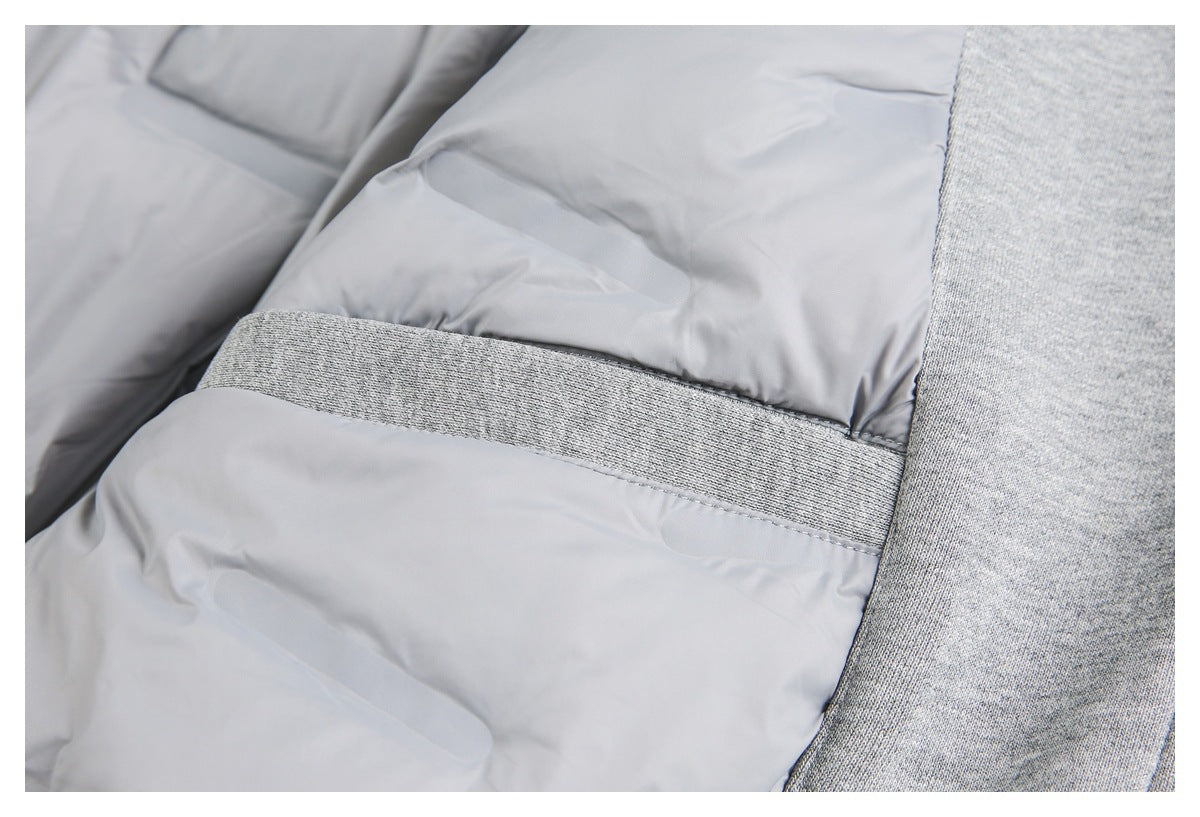 Close-up of light gray quilted jacket lining beside a heather gray knit band and outer panel.