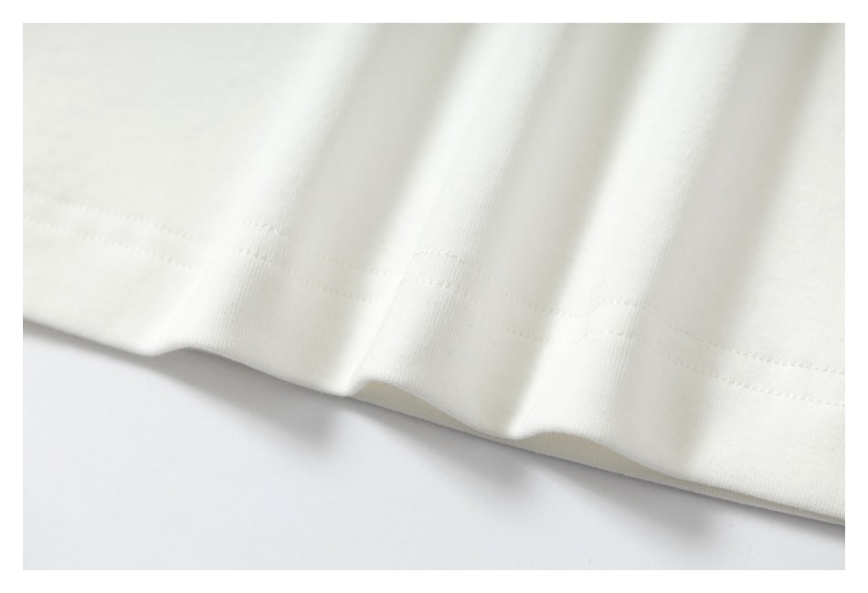 Close-up of a stitched hem on white fabric.