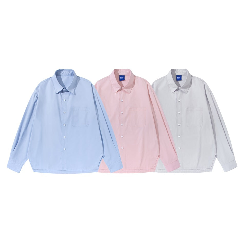 Three long-sleeve button-up shirts shown from the front in light blue, pale pink, and white.