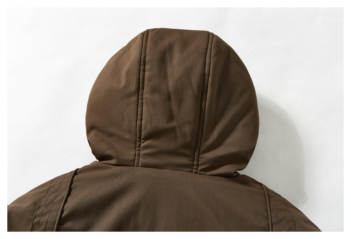 Close-up of the brown jacket's hood and upper back with vertical seam panels.