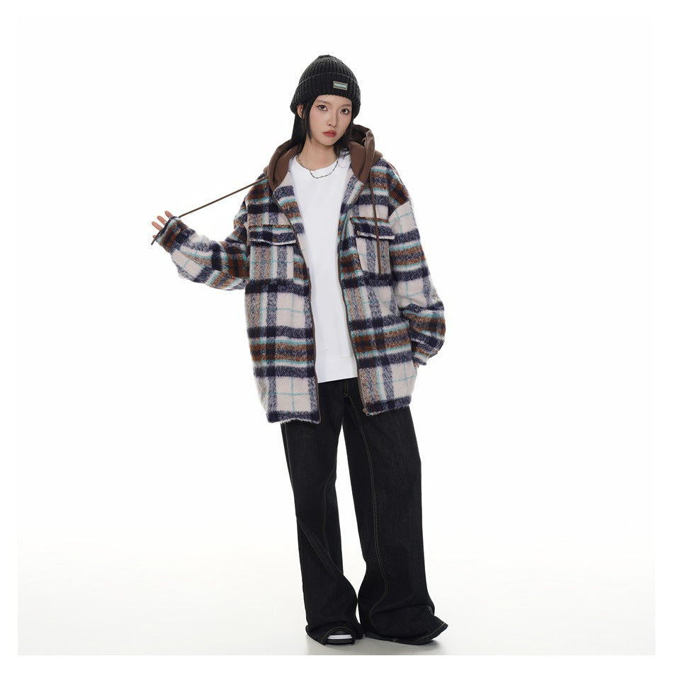 Full-length front view of a person wearing an open white plaid hooded jacket with navy, brown and turquoise lines.