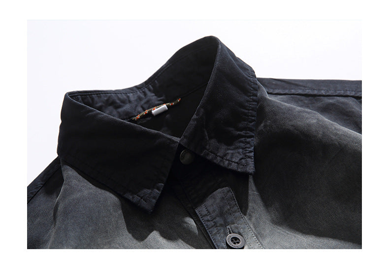 Close-up of a dark charcoal shirt collar, neckline, and button placket.