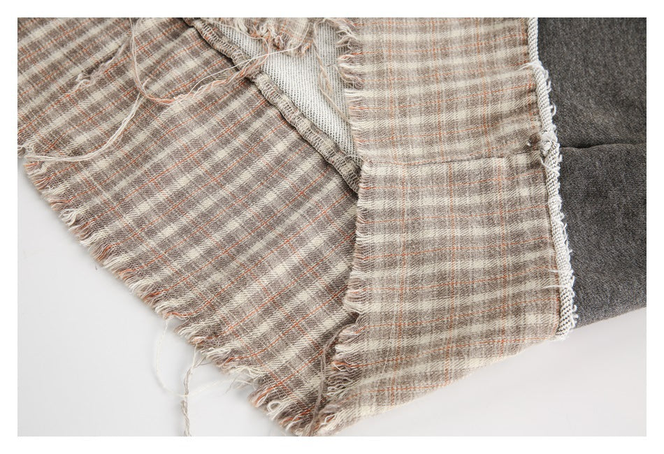 Close-up of the reverse side and construction of the frayed plaid hem panel.