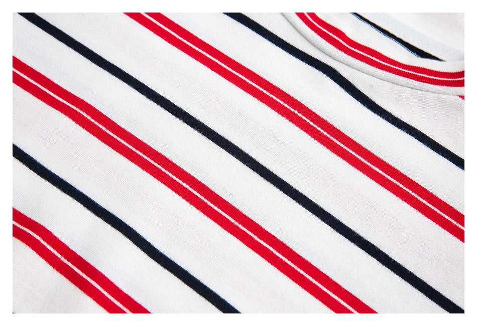 Close-up of white shirt fabric with diagonal red and navy stripes near the neckline.