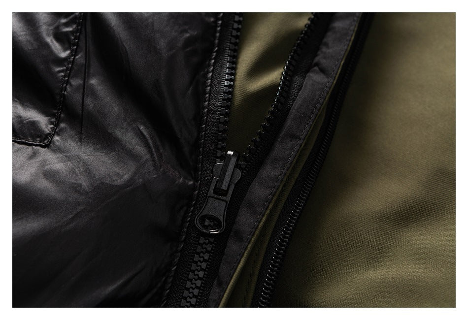 Close-up of a black zipper between the olive outer fabric and dark lining of the jacket.
