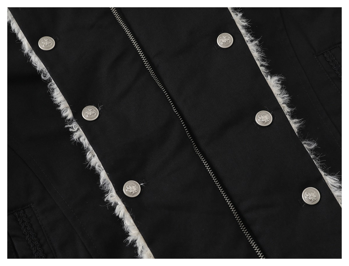 Close-up of a black coat with silver buttons, a zipper, and fluffy white trim along the front edges.