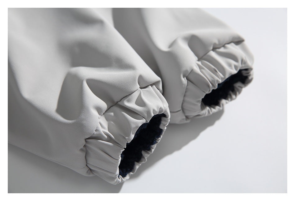 Close-up of two elasticized openings on a light gray garment, each lined with dark navy fabric.