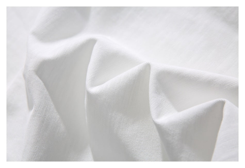 Close-up showing the soft, fine texture and folds of white fabric.