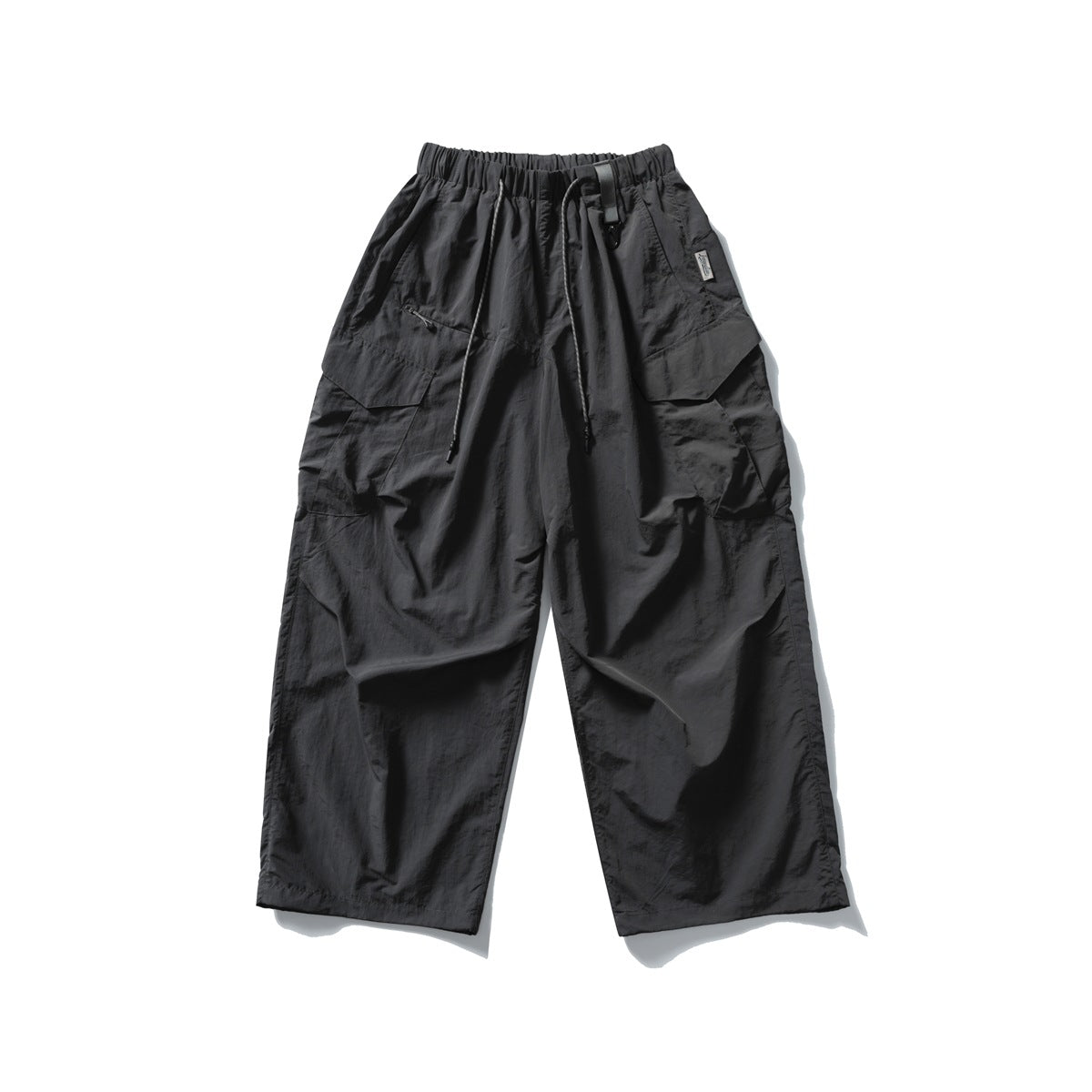 Front view of black wide-leg cargo trousers with an elastic drawstring waist, multiple flap pockets and a small side label.