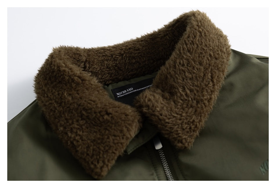 Close-up of an olive bomber jacket collar with thick brown plush lining, front zipper, and visible neck label.