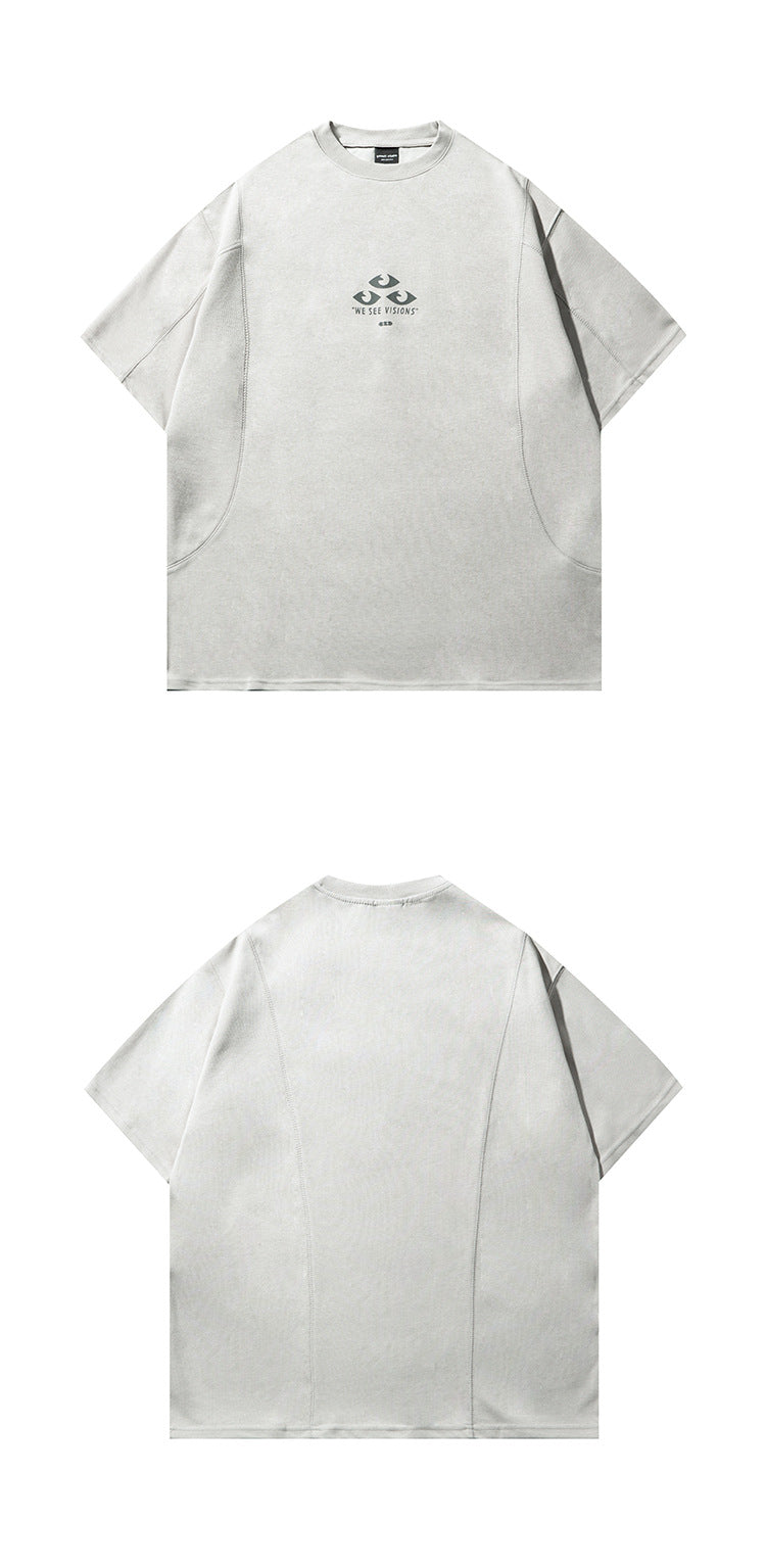 Front and back views of a light gray short-sleeve crew-neck T-shirt; the front has a small eye graphic and “WE SEE VISIONS”