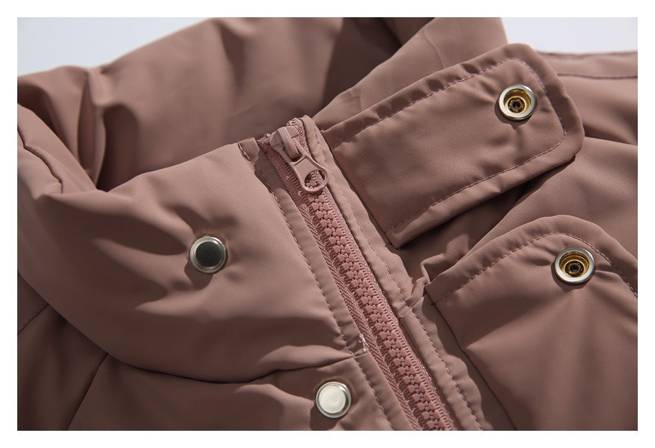 Close-up of a dusty mauve jacket showing its zipper, snap-fastener placket, and flap with a metal snap.