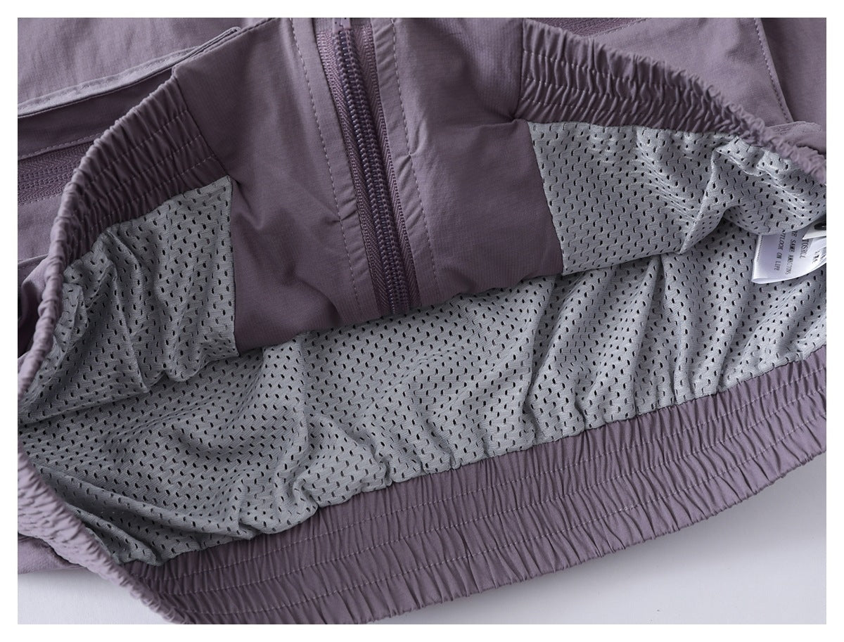 Inside view of the lavender jacket showing perforated mesh lining, zipper, gathered hem, and a sewn-in label.