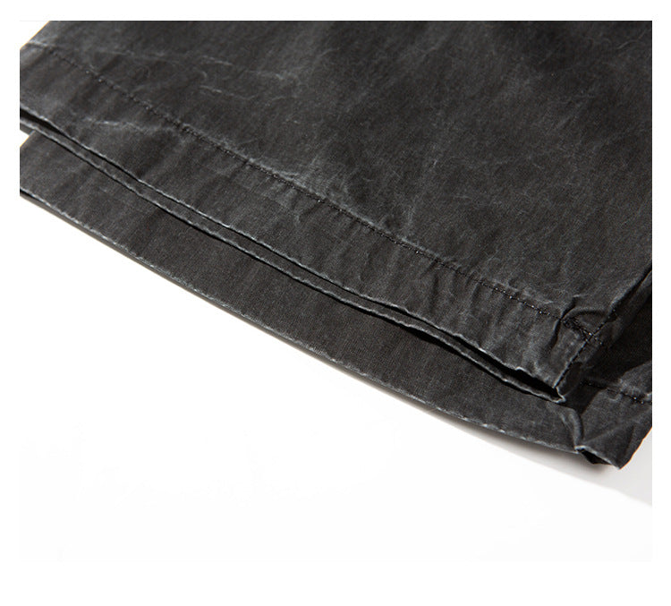 Close-up of the charcoal shirt's curved hem and double rows of stitching.