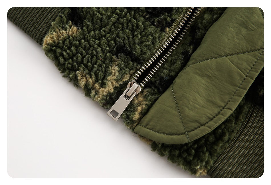 Close-up of a metal zipper beside mottled green fleece and an olive quilted flap.