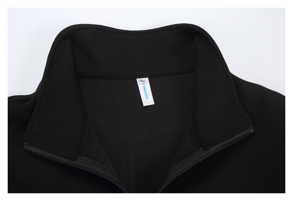 Close-up of a black jacket's inside collar, zipper, and small sewn-in neck label.