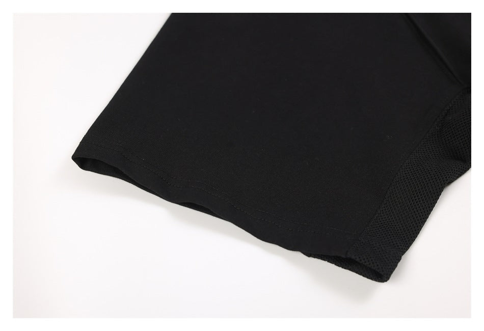 Close-up of the black sweatshirt's sleeve hem beside its mesh side panel.