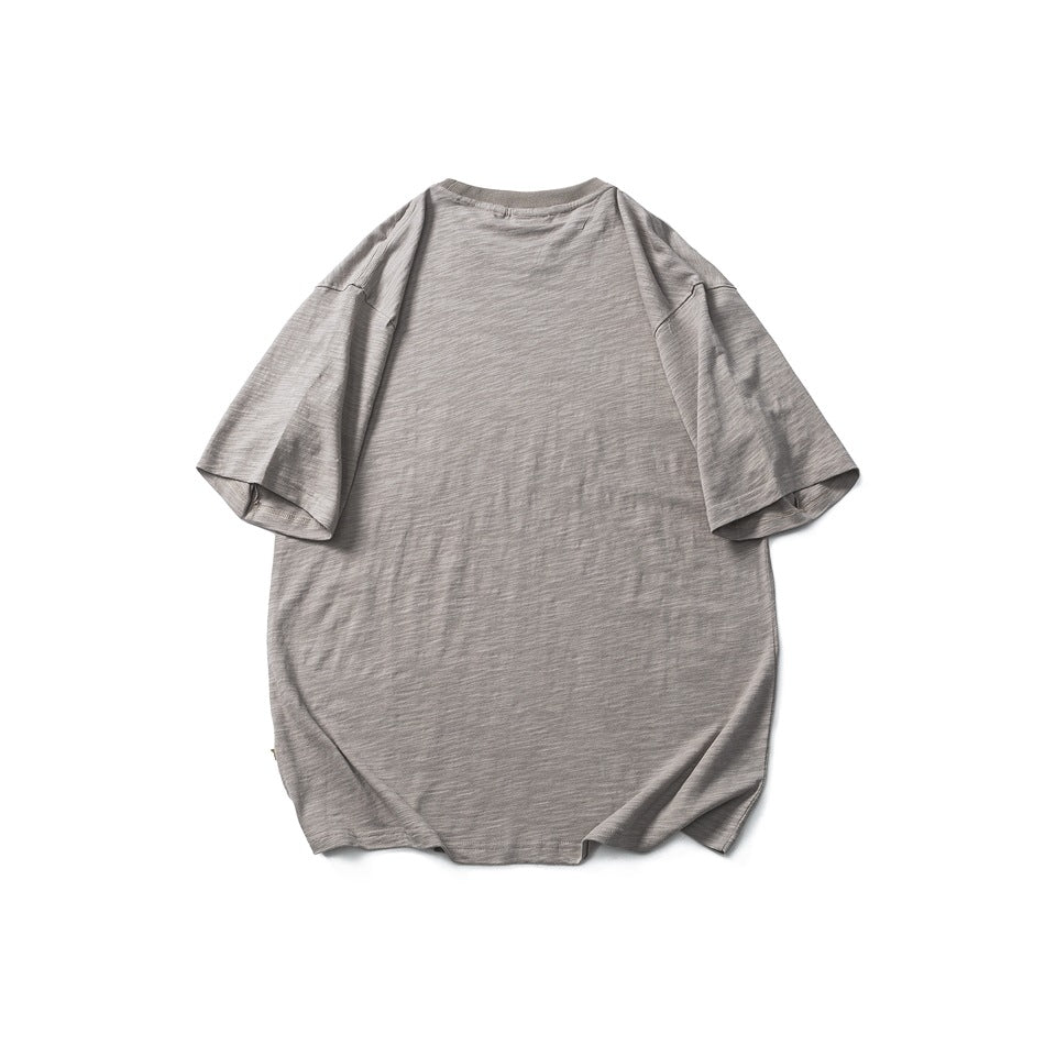 Back view of gray short-sleeve T-shirt with plain textured fabric and ribbed collar, flat lay