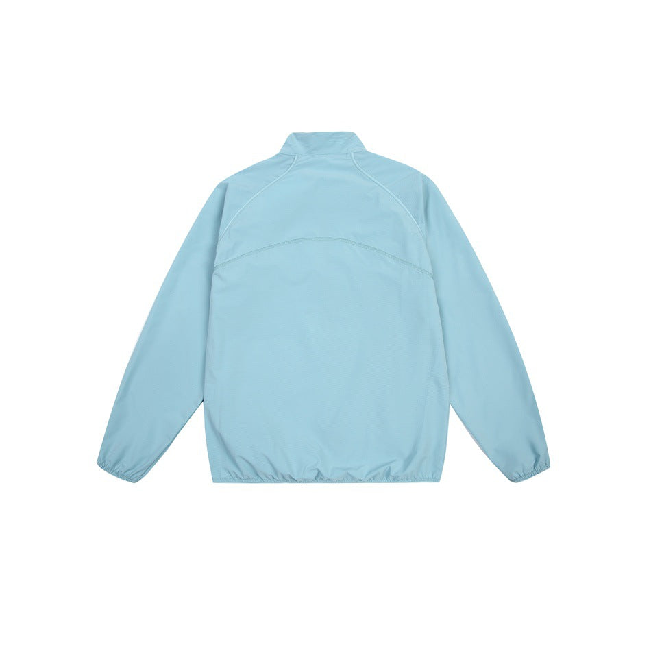 Back view of a light blue long-sleeve jacket with a stand collar, curved seams and elastic cuffs and hem.