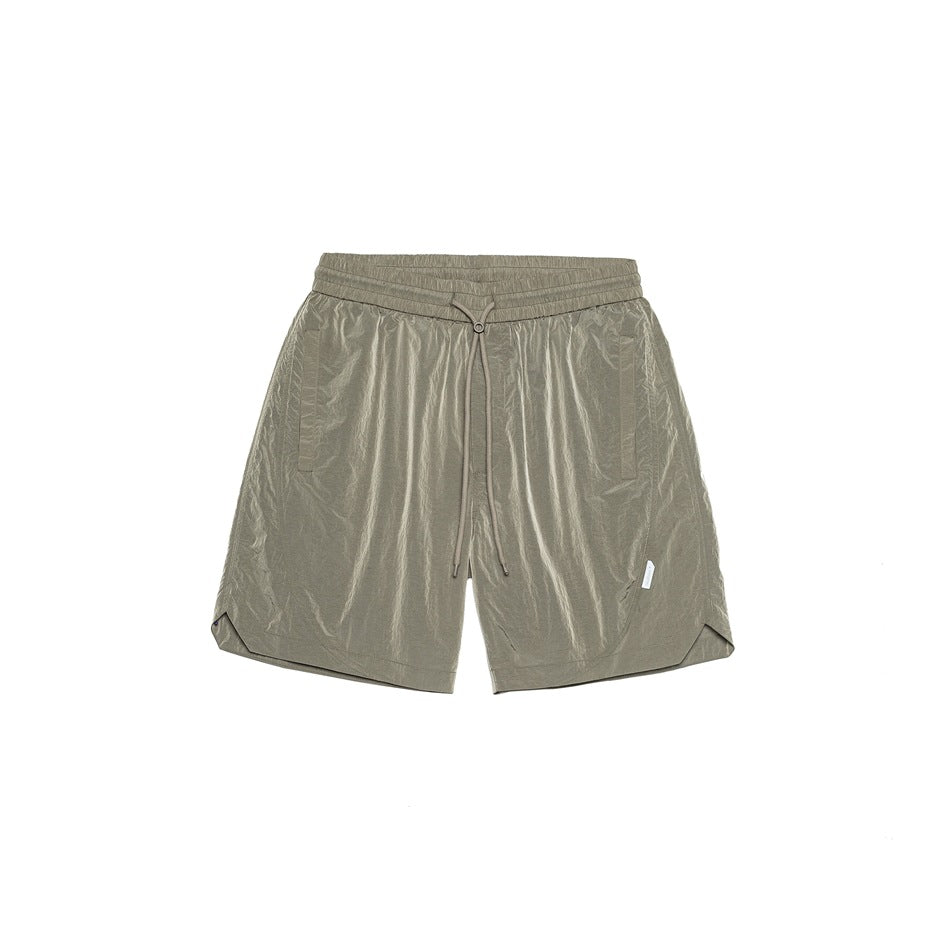 Silver-gray drawstring shorts with crinkled nylon-look fabric, side pockets and curved split hems, flat front view