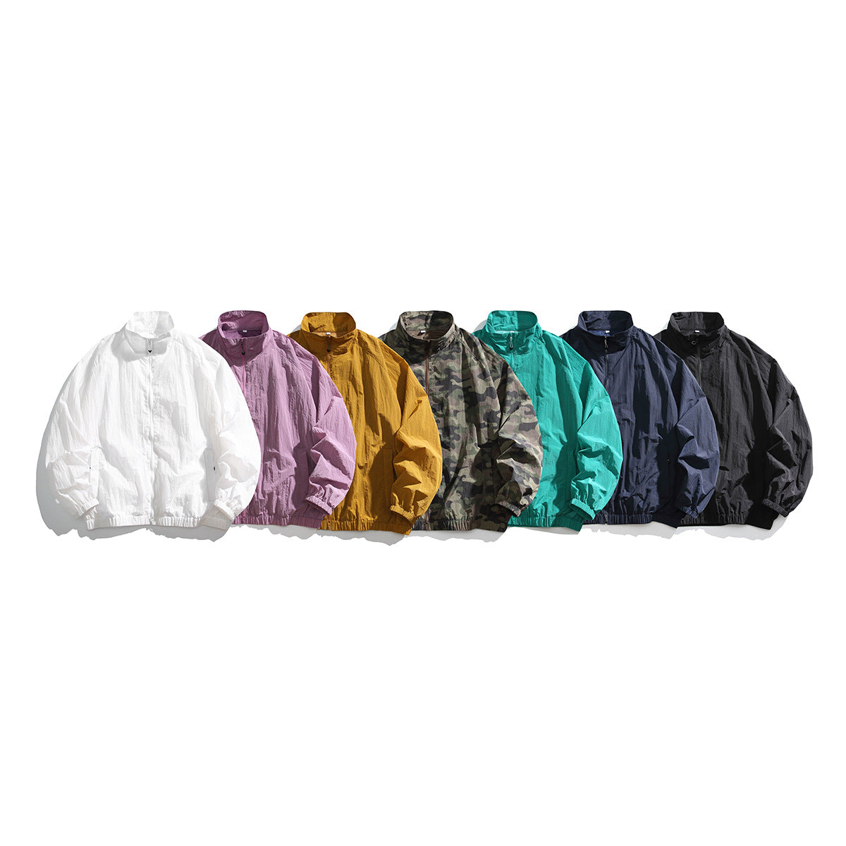 Seven zip-front jackets displayed together in white, mauve, mustard, camouflage, teal, navy and black.