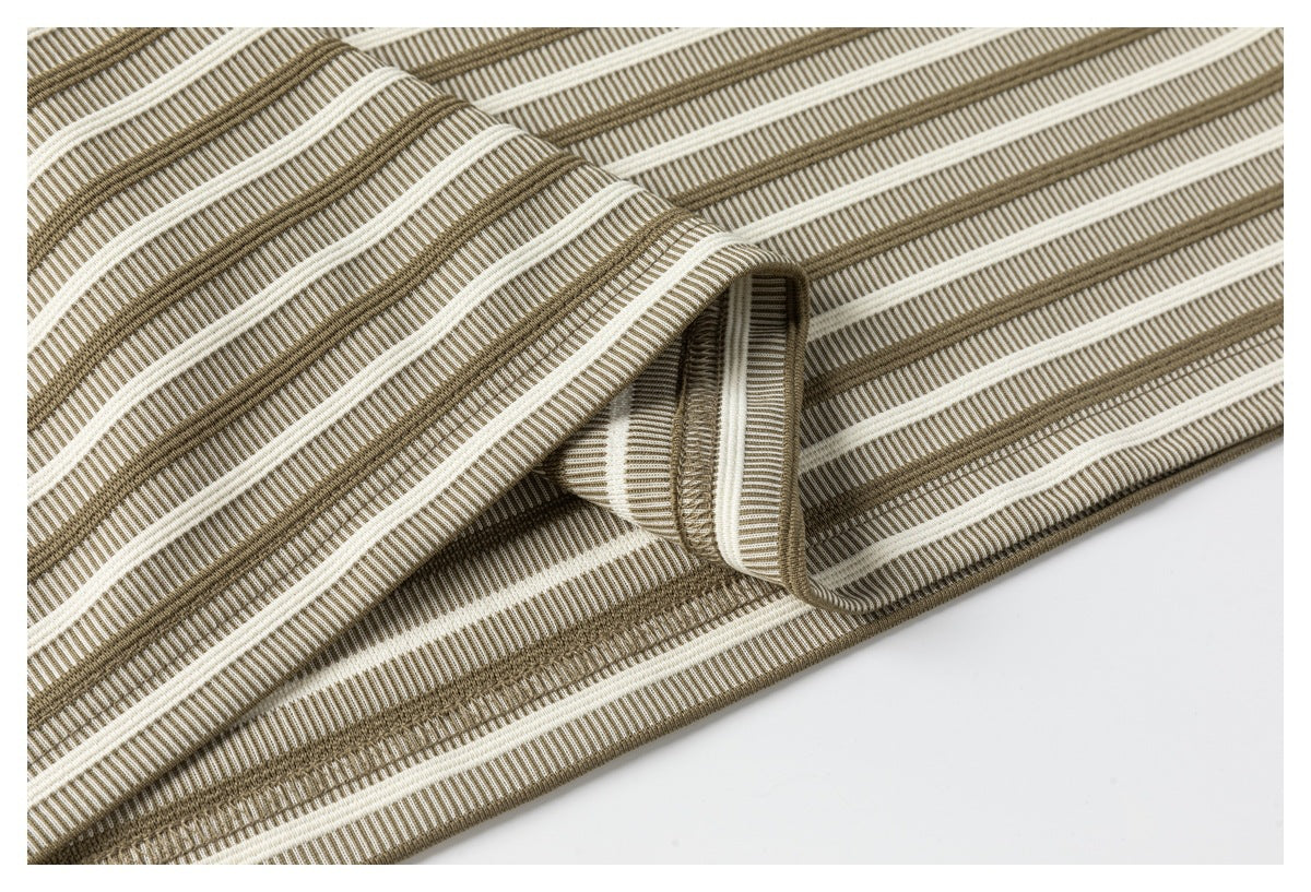 Close-up of a folded edge showing the striped shirt fabric and stitched seam finish.
