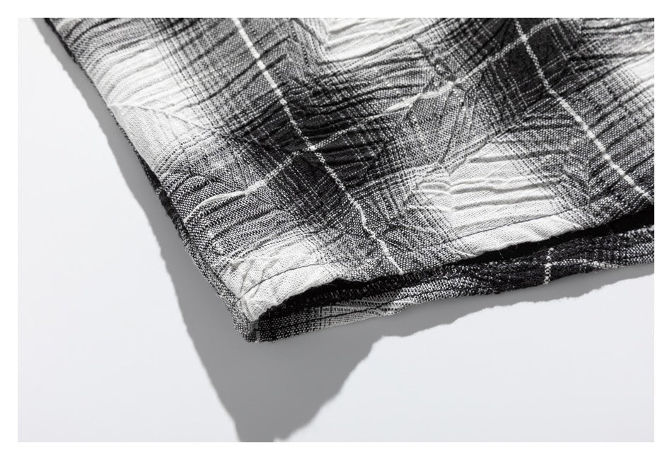 Close-up of the folded hem of a black-and-white plaid garment.