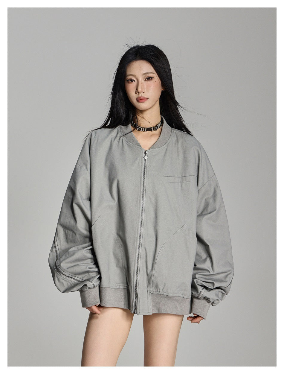 Model wearing a light gray oversized zip-front jacket with a ribbed collar, cuffs and hem, and curved front pockets.