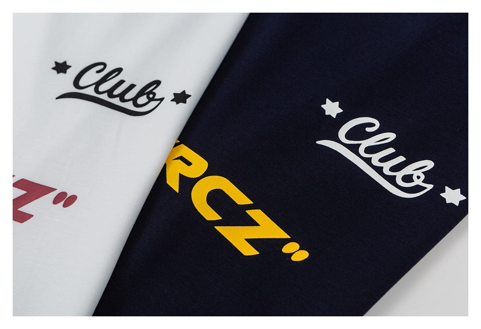 Close-up of white and navy fabric with star-and-script graphics and partial red and yellow lettering.