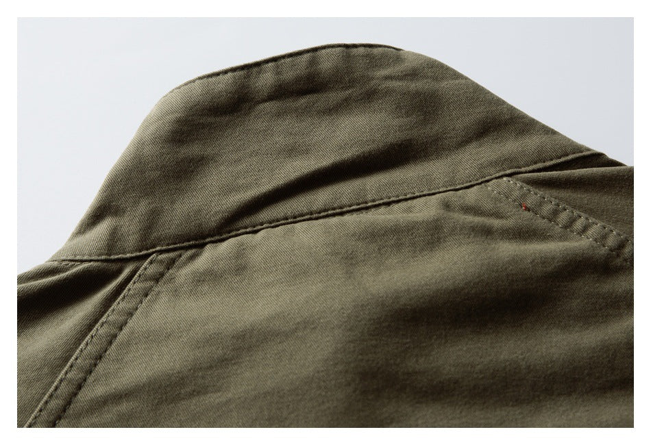 Close-up of an olive-brown garment collar and intersecting stitched seams.