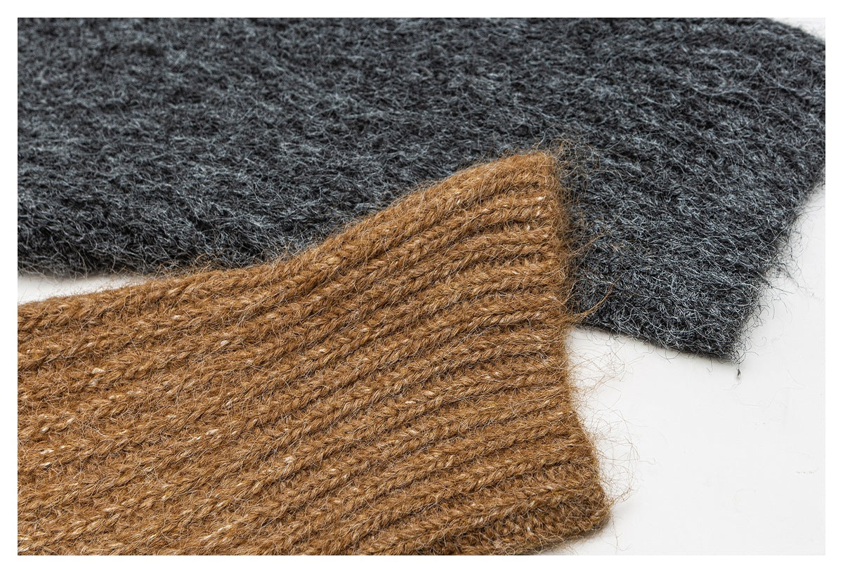 Close-up of charcoal and camel-brown knitted fabric pieces, highlighting their fuzzy texture and stitching.