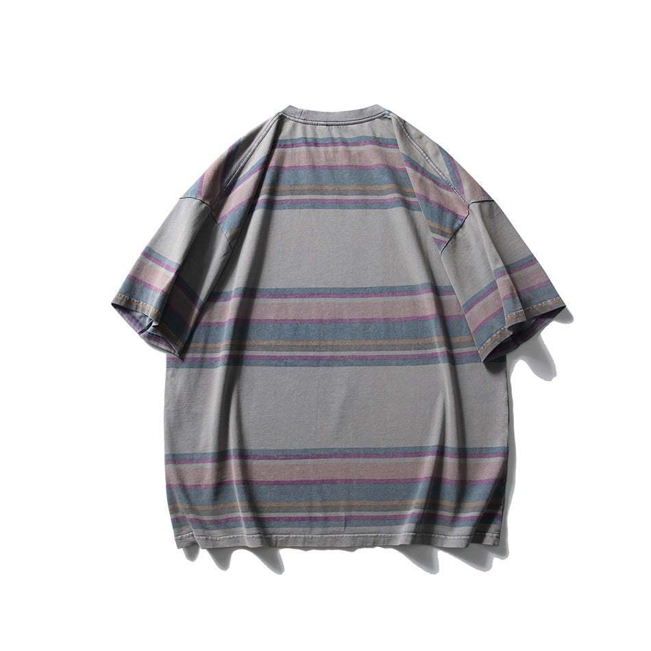 Back view of a loose gray short-sleeve T-shirt with horizontal muted pink, blue, and tan stripes.
