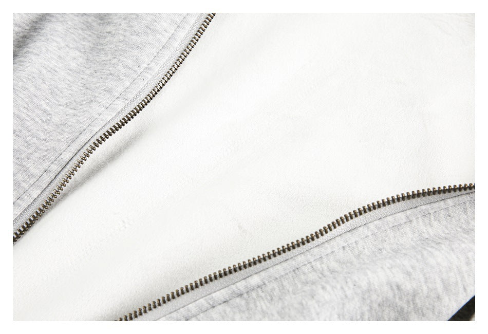 Close-up of the light gray jacket's open zipper and pale inner lining.