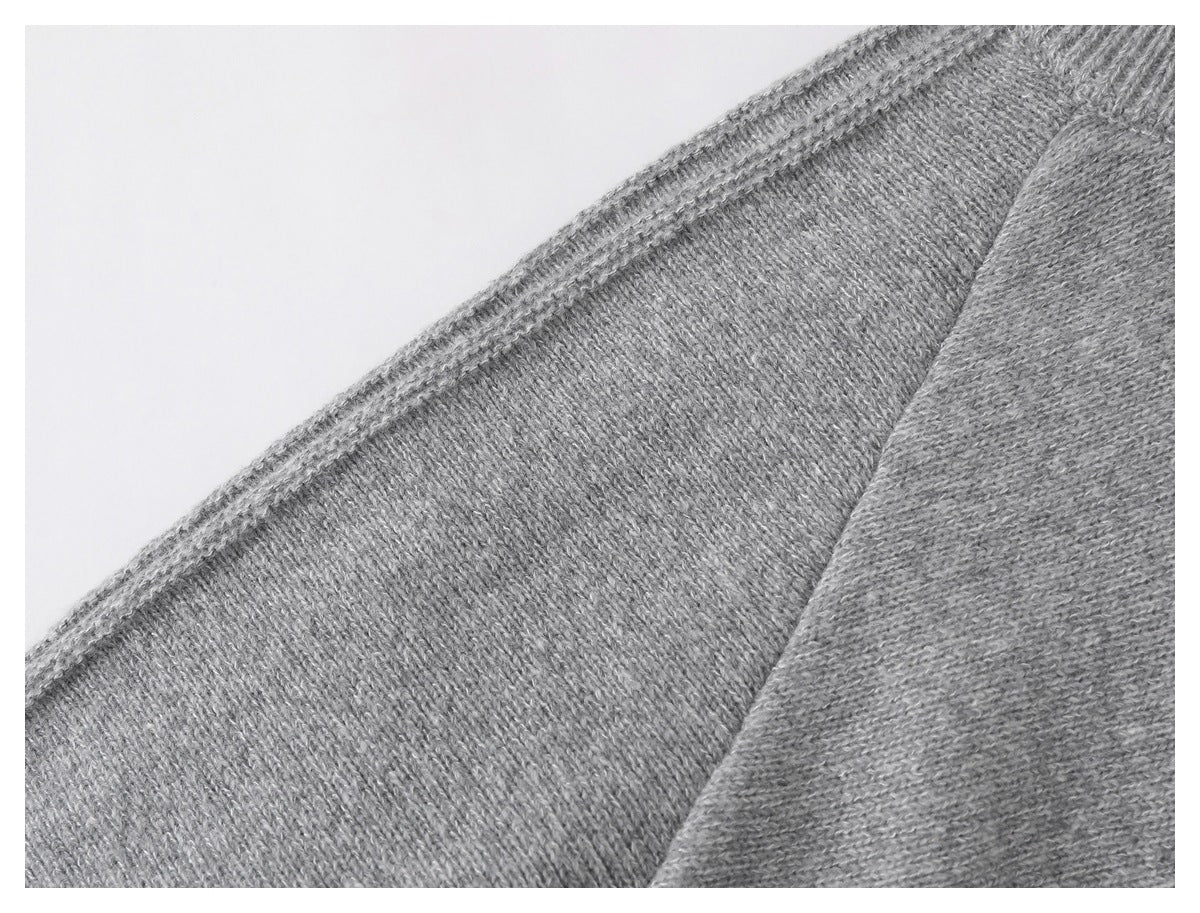 Close-up of gray knit panels and a stitched seam.