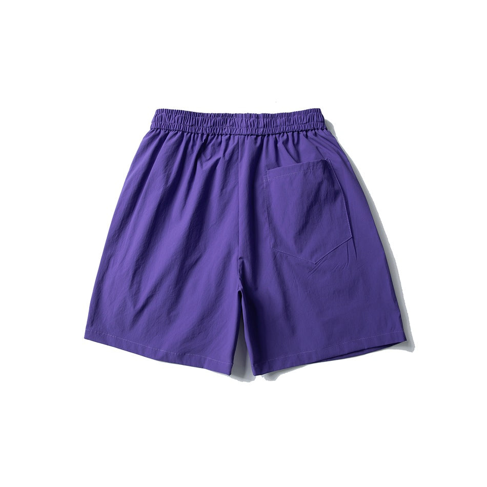 Purple shorts back view with elastic waistband and a single patch pocket on the right side