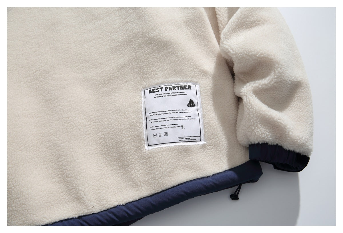 Close-up of a cream fleece jacket with navy trim, a drawcord, and a sewn BEST PARTNER label.