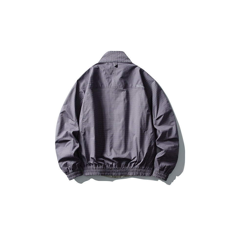 Back view of a dark gray-purple jacket with a fine check pattern, stand collar, gathered cuffs, and elasticated hem.