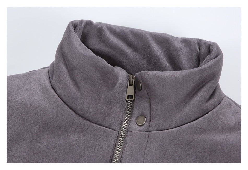 Close-up of a charcoal gray jacket's high collar, metal zipper, and snap fastening.