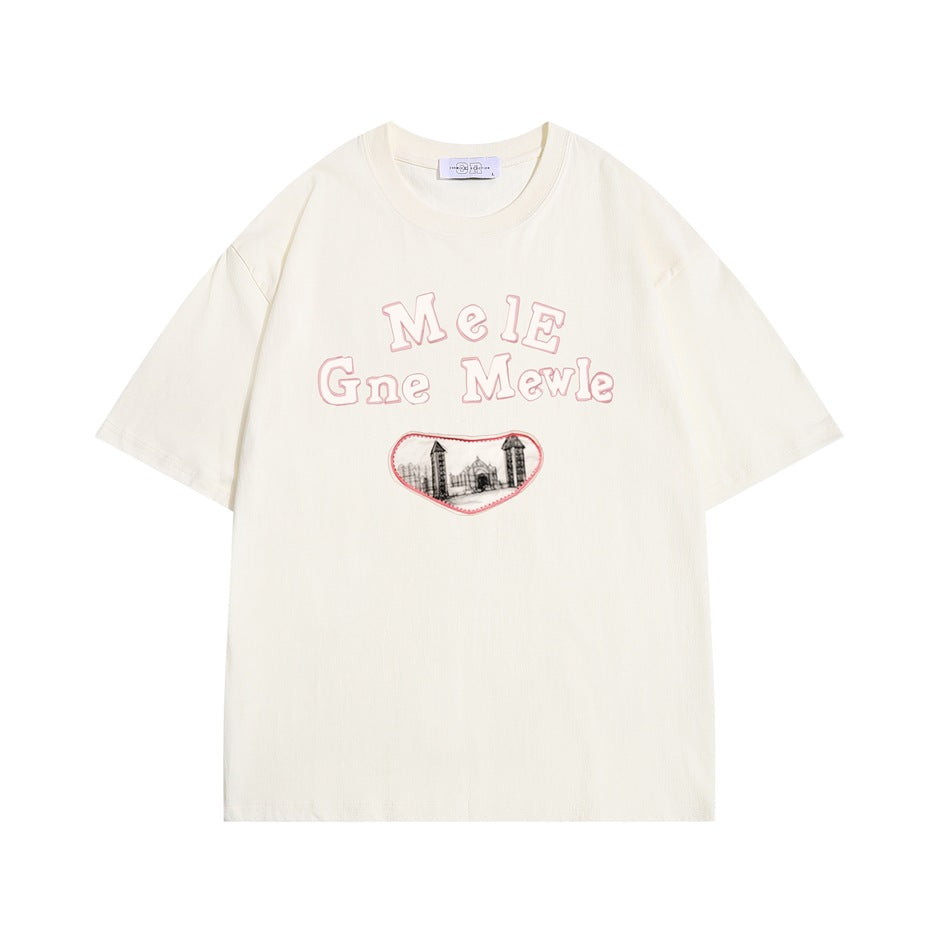 Apricot cream short-sleeve crew-neck T-shirt with pink-outlined lettering and a gated building patch on the front