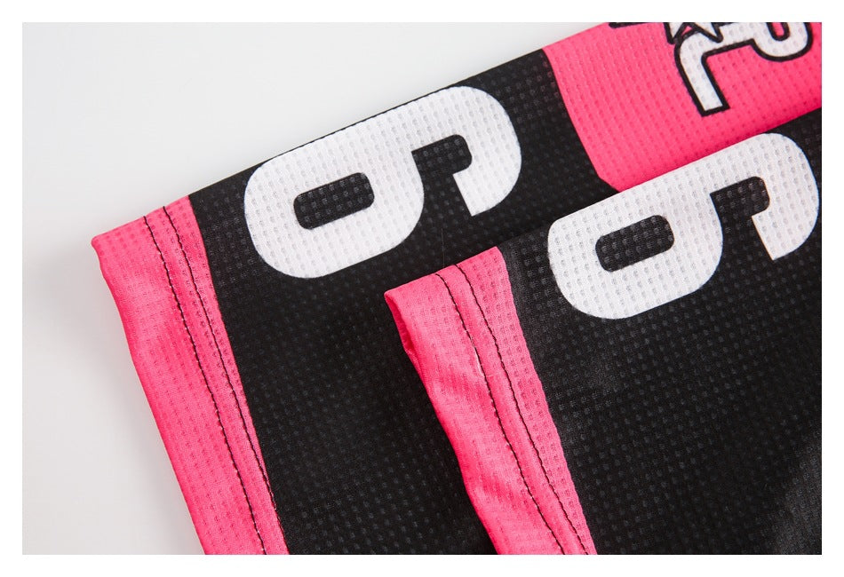 Close-up of two folded sections of black and pink jersey fabric with white lettering and stitched hems.