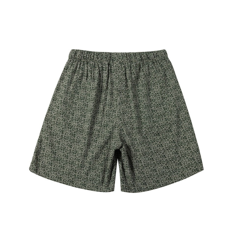 Back view of green and cream paisley print shorts with elastic gathered waistband, flat lay