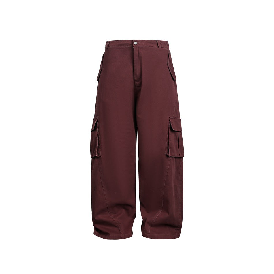 Front view of loose burgundy cargo trousers with a button waist and flap pockets.