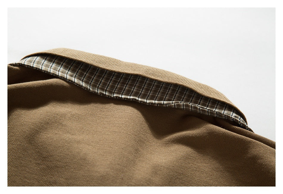 Inside view of a brown polo shirt collar with plaid lining.