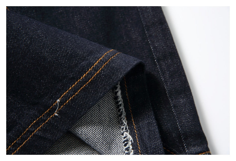 Close-up of a folded denim edge showing the inner weave and overlocked seam.