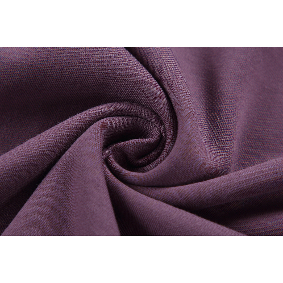 Macro view of plum-colored fabric gathered into a spiral, showing its surface texture.