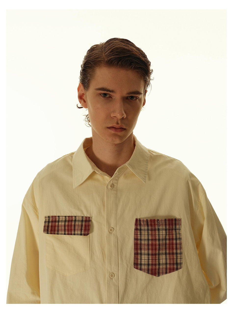 Close-up of a model wearing an apricot shirt showing the collar, buttons and plaid pocket details