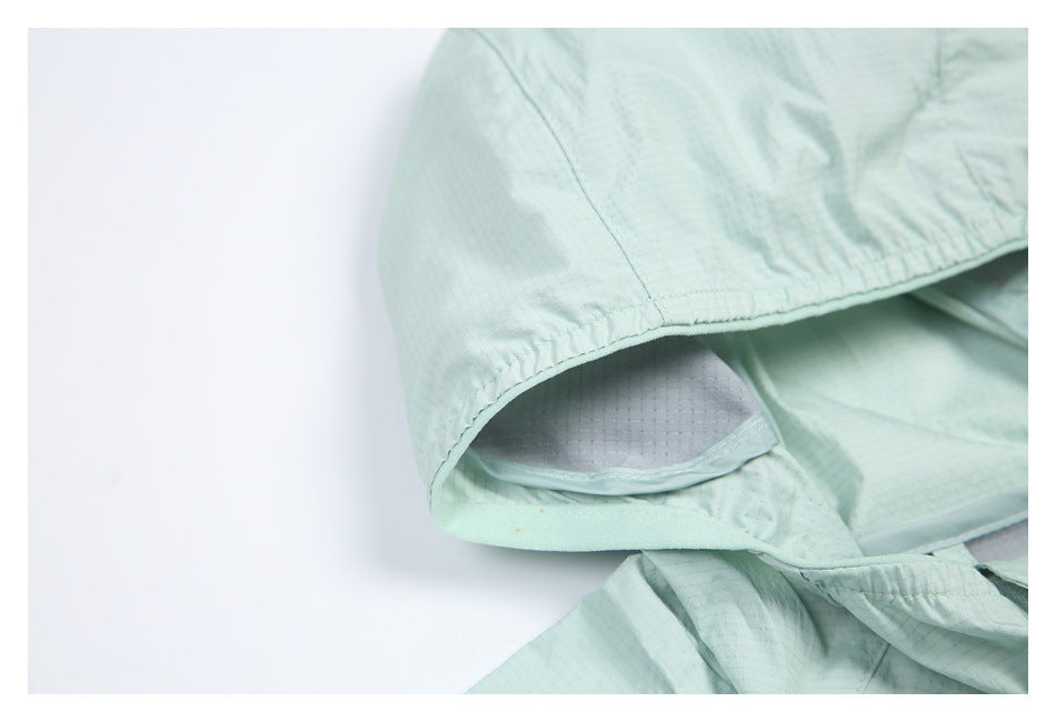 Close-up of the mint jacket hood opening, showing its gathered edge and light gray inner panel.